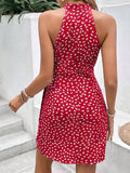 Back view of coral wrap-style mini dress with halter neckline