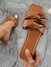 Experience ultimate comfort and style with Vacation Ready: Women's Brown Bowknot Detail Flat <a href="https://canaryhouze.com/collections/women-canvas-shoes" target="_blank" rel="noopener">Sandals</a>. Crafted with bowknot detailing, these sandals are perfect for a day at the beach or a stroll through the city. The flat design provides all-day wearability, making these sandals the perfect addition to your vacation wardrobe.