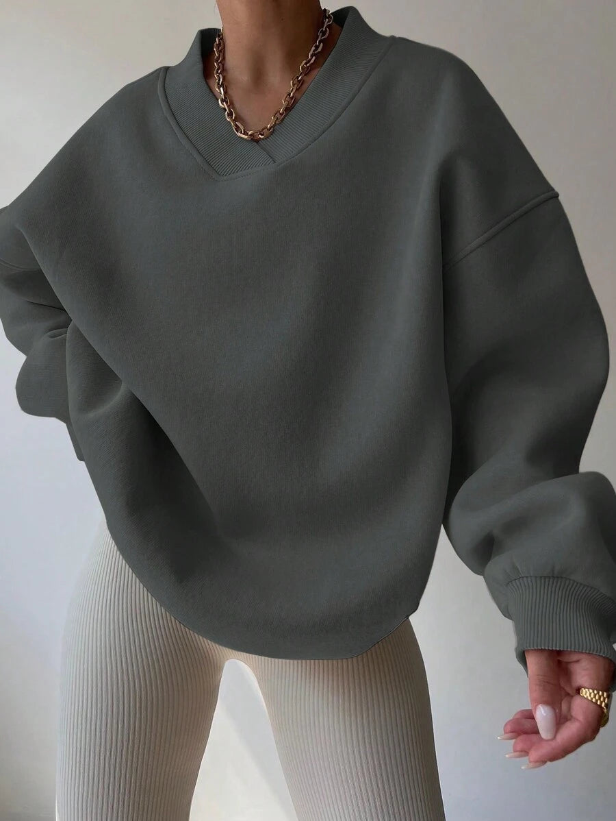Front view of grey oversized V-neck sweatshirt with dropped shoulders