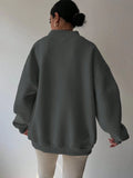 Back view of grey oversized sweatshirt with loose long sleeves and rib-knit trim