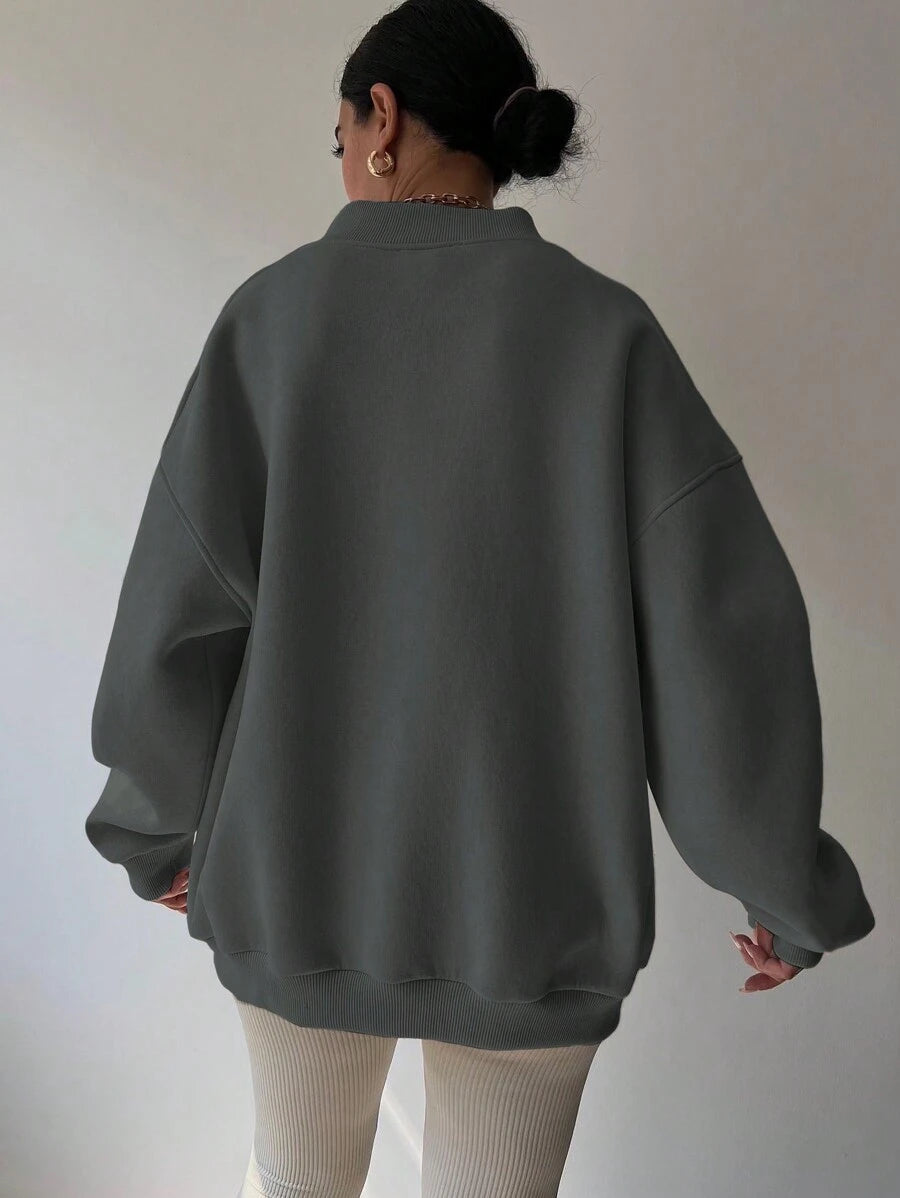 Back view of grey oversized sweatshirt with loose long sleeves and rib-knit trim