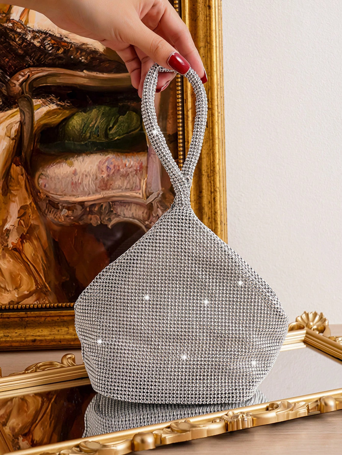 This Geometric Glamour Mini Diamond Evening Bag is the perfect accessory for any party. With its stunning geometric design and sparkling diamond embellishments, it is sure to make a statement. The compact size allows for easy carrying of all your party essentials. Elevate your style and make a lasting impression with this glamorous evening bag.