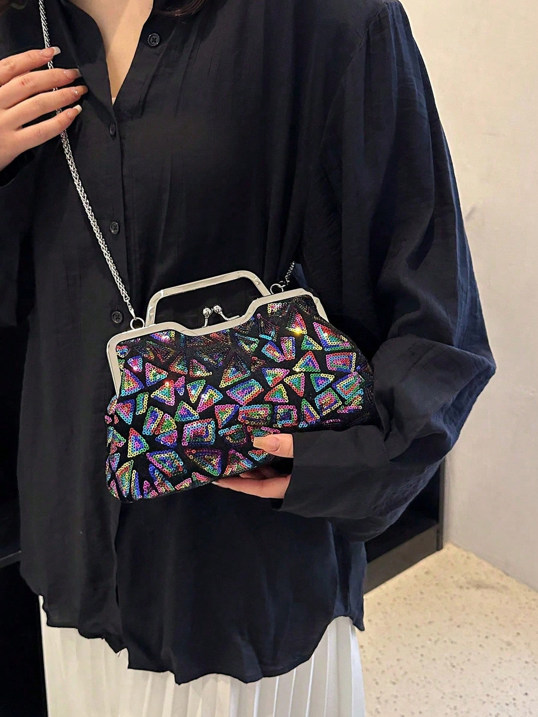 Elevate your evening ensemble with the Shimmering Nights: Square-Shaped Sequined Evening Clutch Bag. The sleek square-shaped design and sparkling sequins will add a touch of glamour to any outfit. With its compact size and secure closure, you can confidently carry your essentials for a night out.