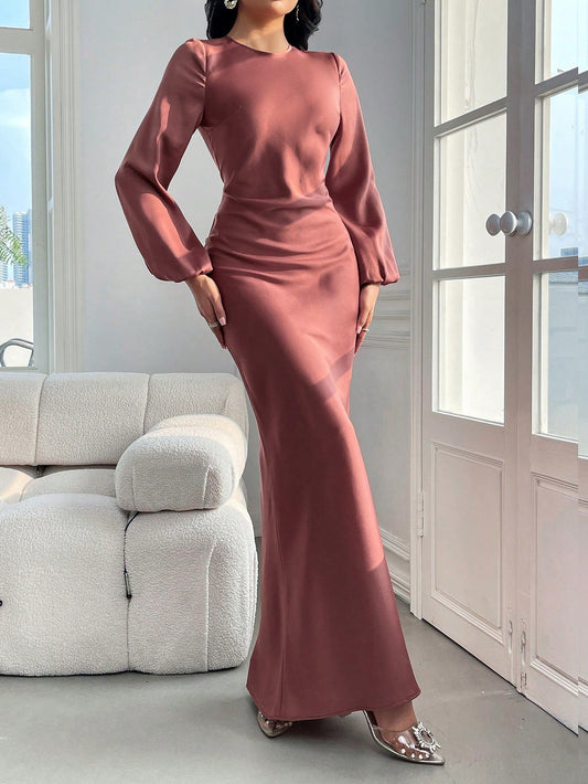 The Elegantly Classic dress features a timeless design with solid bishop sleeves and a mermaid hem, creating a flattering silhouette. Crafted with high-quality materials, this dress exudes sophistication and elegance. Perfect for any formal occasion, it's a must-have for every wardrobe.