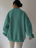 Back view of mint green oversized sweatshirt with wide rib-knit hem