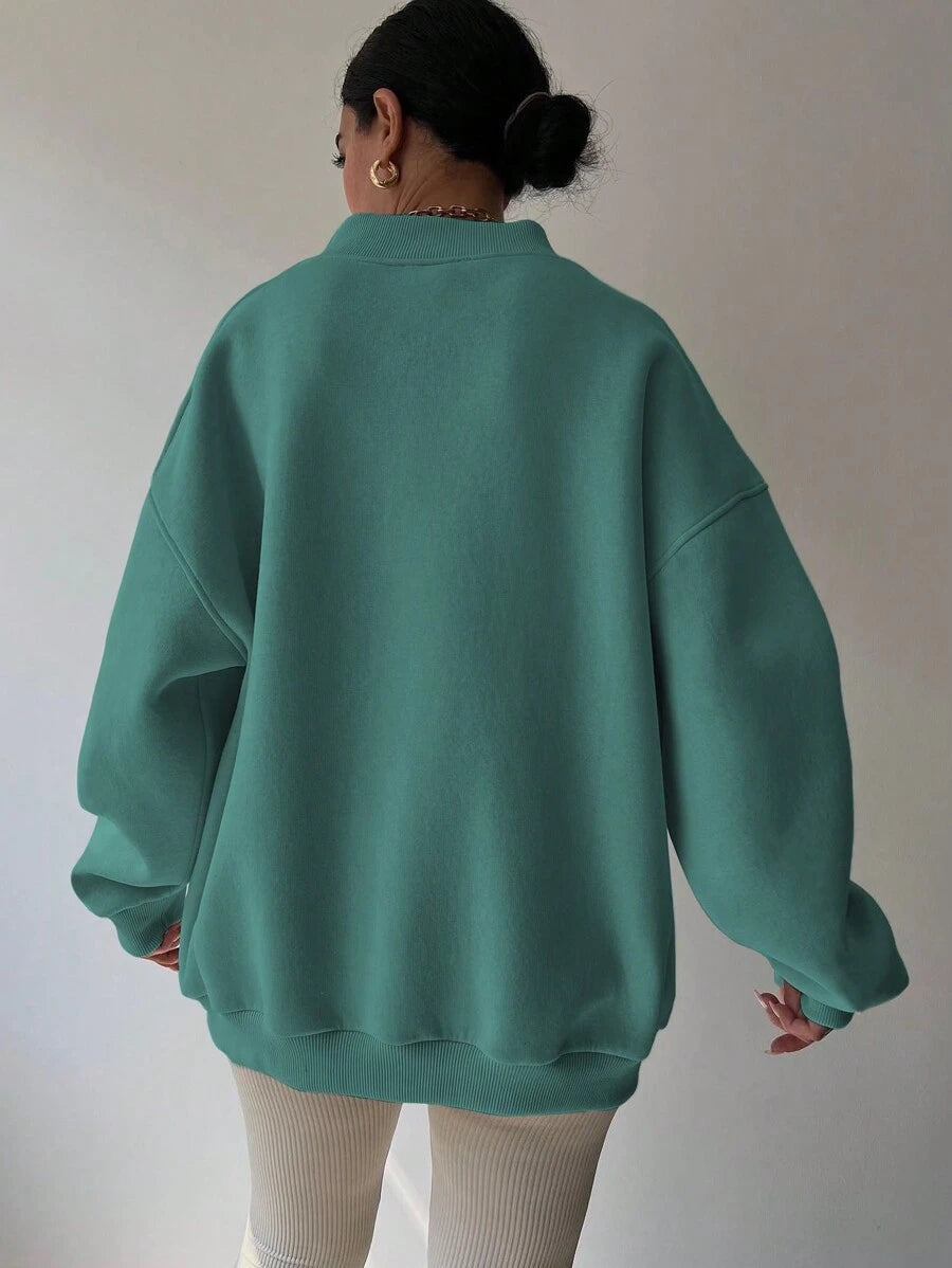 Back view of mint green oversized sweatshirt with wide rib-knit hem