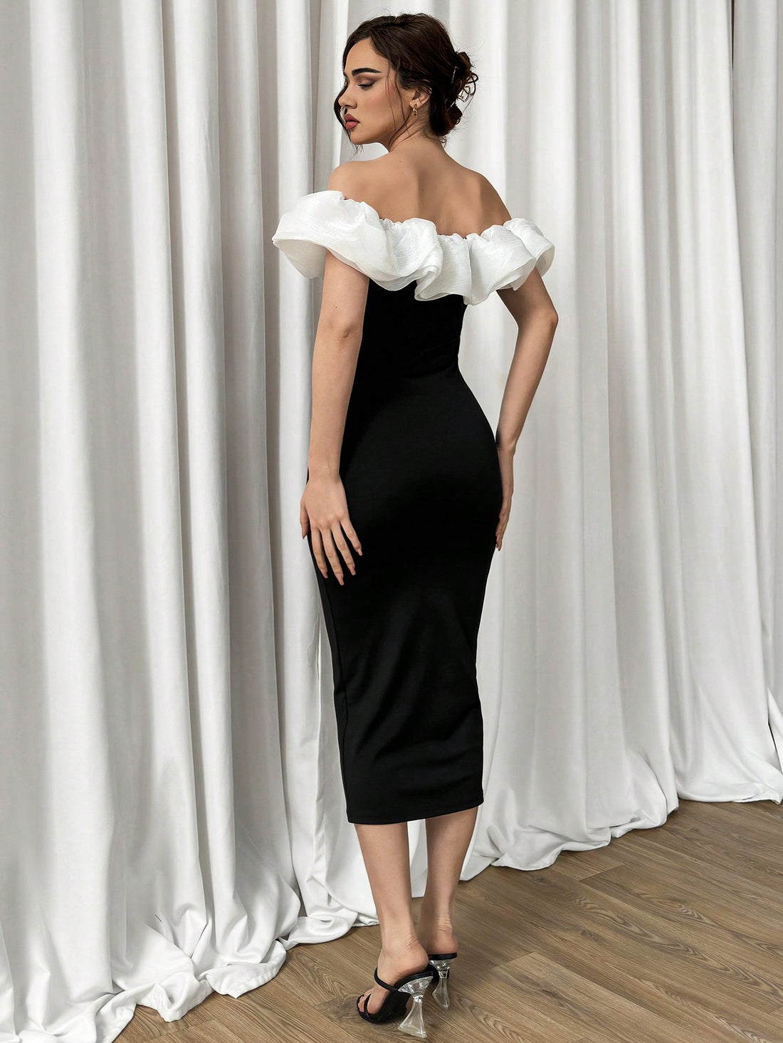 This elegant ruffled long dress combines a striking black and white contrast with a one shoulder design for a sleek and sophisticated look. Made for the modern woman who wants to make a statement, this dress is perfect for any formal occasion. Feel confident and stylish in this timeless piece.