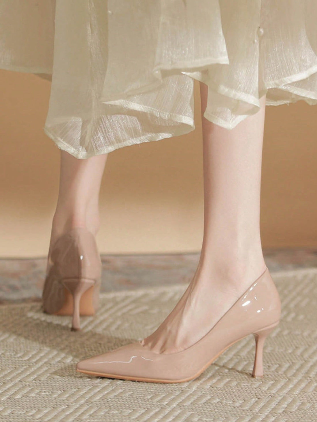 Step into spring with confidence in these stunning nude patent leather pumps. Their sleek, polished finish catches the light beautifully, making them the perfect companion for boardroom meetings or weekend brunches. The classic high heel silhouette elongates your legs while the neutral shade pairs effortlessly with everything in your wardrobe—from tailored trousers to flowing dresses. Whether you're climbing the corporate ladder or simply elevating your everyday look, these versatile heels deliver timeless 