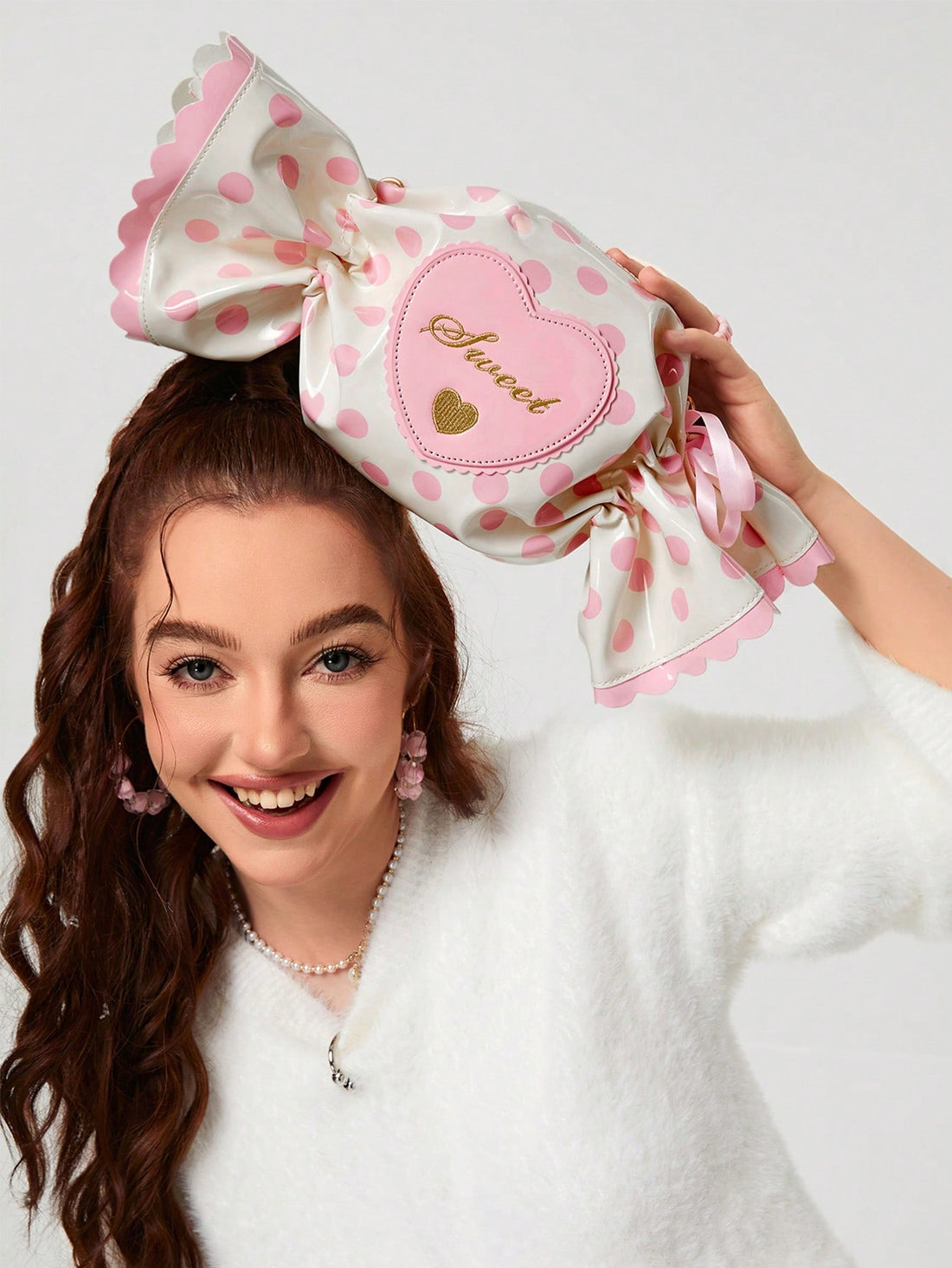 This polka dot candy chain crossbody bag is both sweet and stylish, perfect for girls and women alike. Made with high-quality materials, it adds a fun touch to any outfit. The adjustable strap makes it convenient to wear, and the spacious interior allows for easy organization. A must-have accessory for any fashion-forward individual.