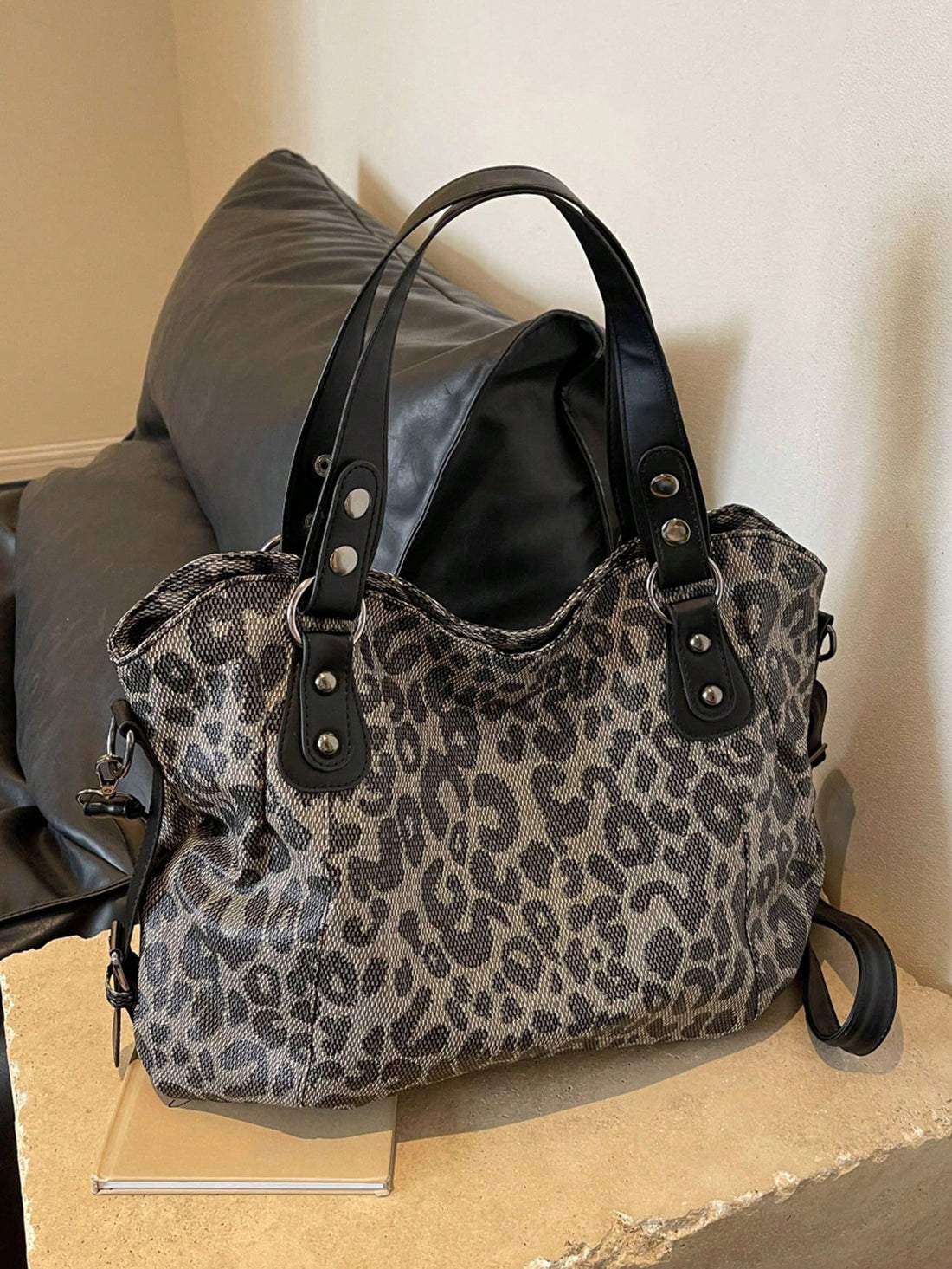 This Leopard Design Print Retro Style Tote Bag features a bold and trendy leopard print, perfect for making a statement. With a spacious interior, this bag can hold all your daily essentials and more. Its Korean crossbody design adds a touch of modernity to its retro style. Expertly crafted for both fashion and function.