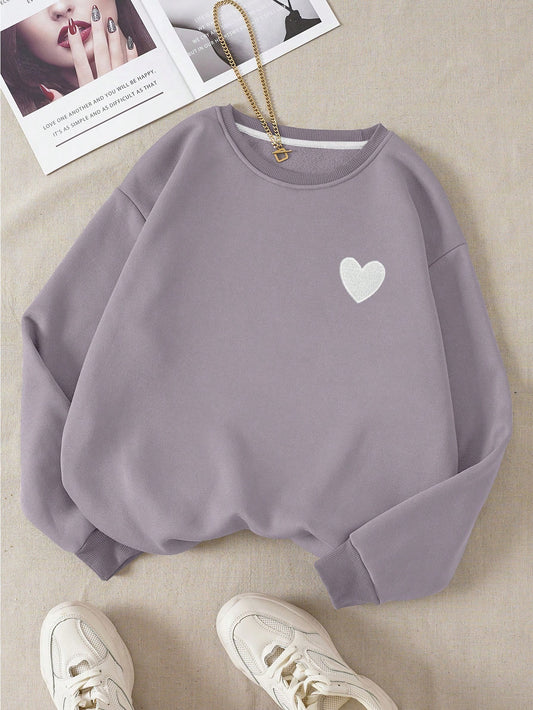 Stay warm and stylish with our Sweetheart Sweater! This cozy long sleeve drop shoulder sweatshirt features a cute heart print, perfect for any casual look. Made from premium materials, it'll keep you comfortable all day long. Upgrade your wardrobe with this must-have piece!