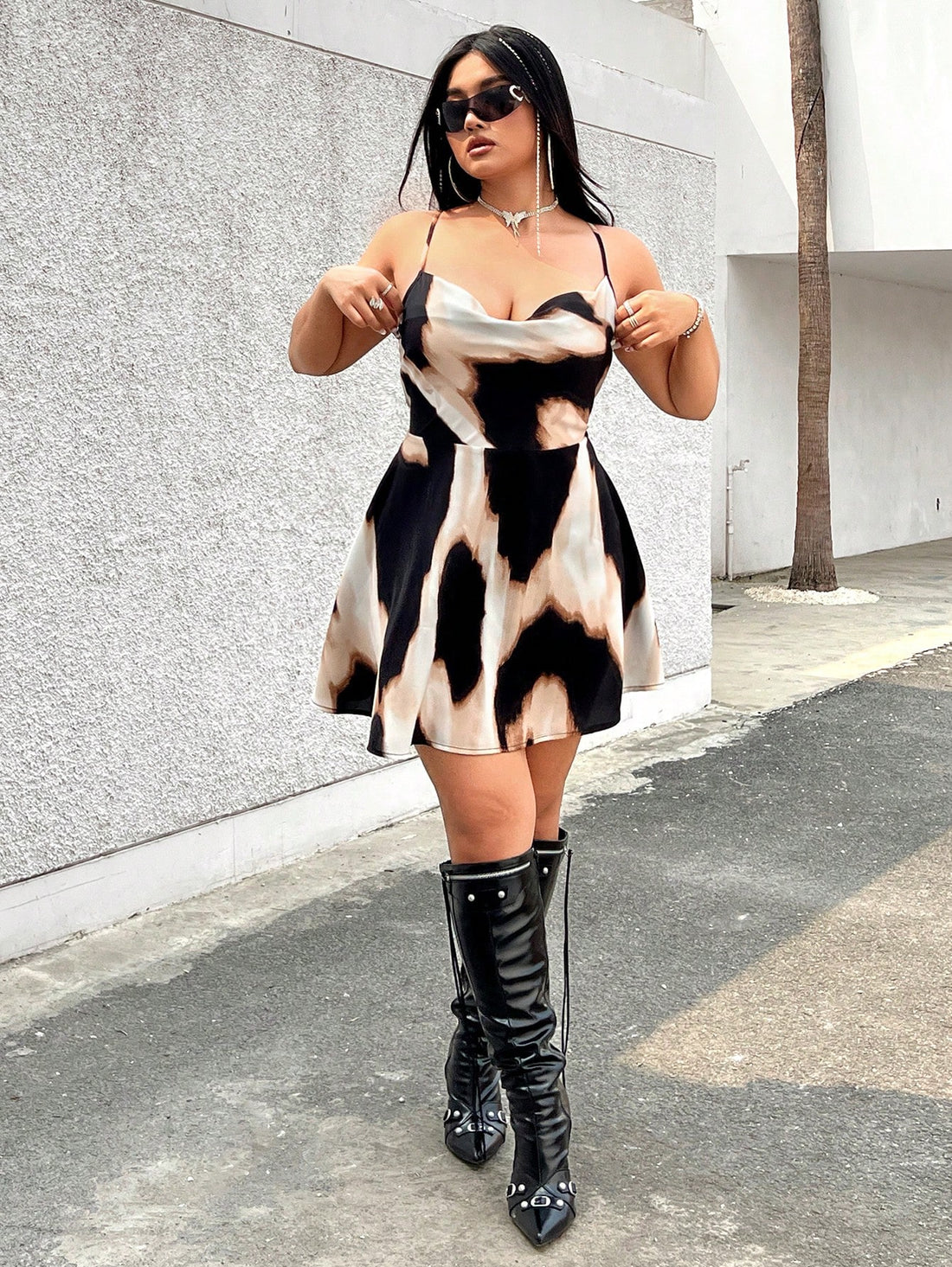 Enhance your summer wardrobe with Chic Summer Vibes: Plus Size Tie-Dye Backless Cami Dress. The chic tie-dye design and backless style exude effortless style, perfect for any summer occasion. Plus, the comfortable fit in a range of sizes ensures you'll feel confident and chic at the same time. Elevate your summer vibes today.