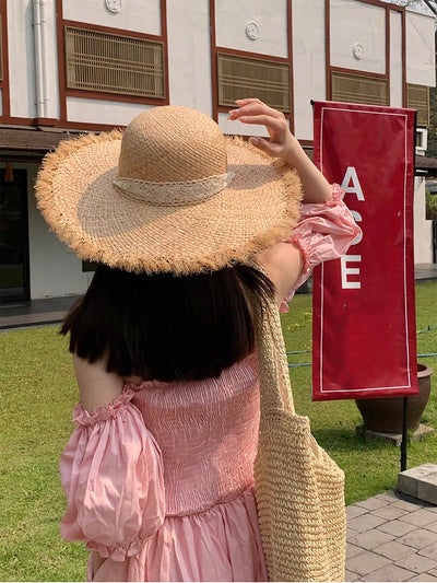 Stay stylish and protected with our wide brimmed raffia straw beach hat. Shield yourself from the sun while elevating your beach look. Made with high-quality materials for durability and comfort. A must-have accessory for any beach day.