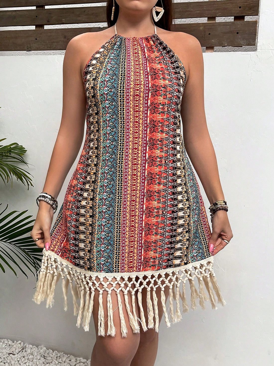 Dress up for your next beach vacation in this Boho Chic halter neck dress. With a tassel hem and vibrant print, this plus size dress is perfect for a day out in the sun. So go ahead and make a statement, because you deserve to look and feel your best!