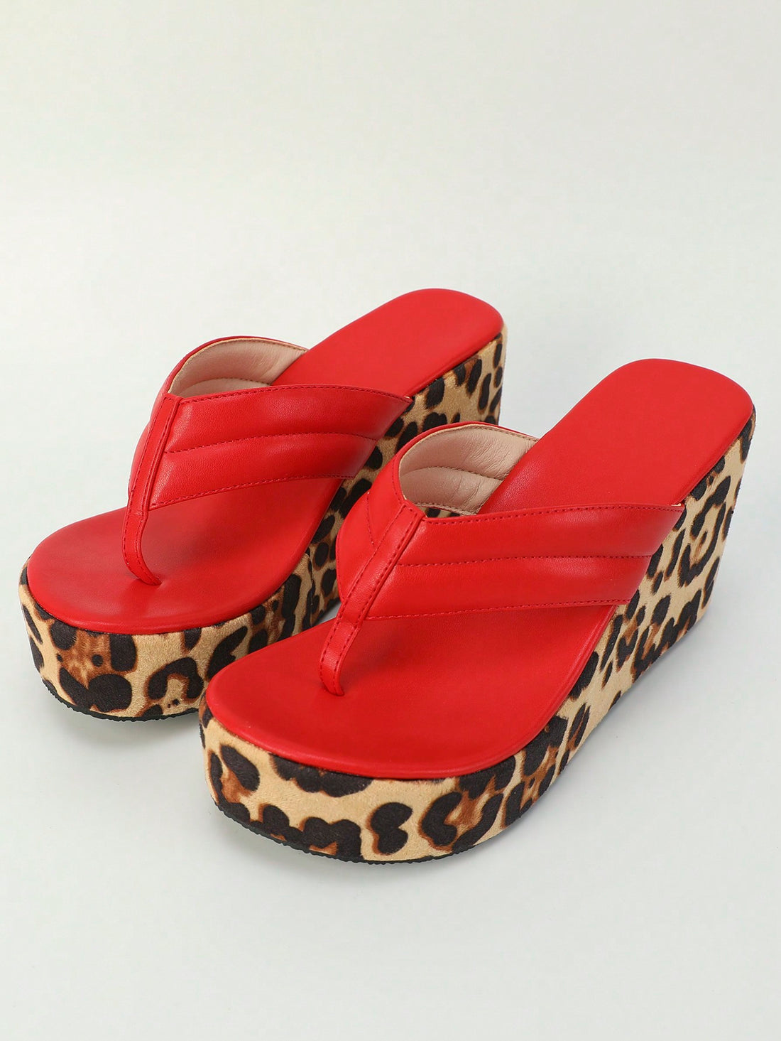 Add a pop of fun to your Spring and Summer style with our Chic Red Leopard Print Wedge Heel Sandals. These sandals not only bring a touch of boldness to any outfit, but also provide a comfortable and stylish wedge heel. Perfect for a playful and trendy look!