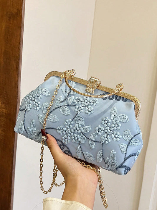 Expertly crafted with delicate blue lace embroidery, this elegant handbag is the perfect accessory for any special occasion. Its sophisticated design and high-quality materials exude a sense of luxury and style. With enough space to hold all your essentials, this handbag is both functional and fashionable.