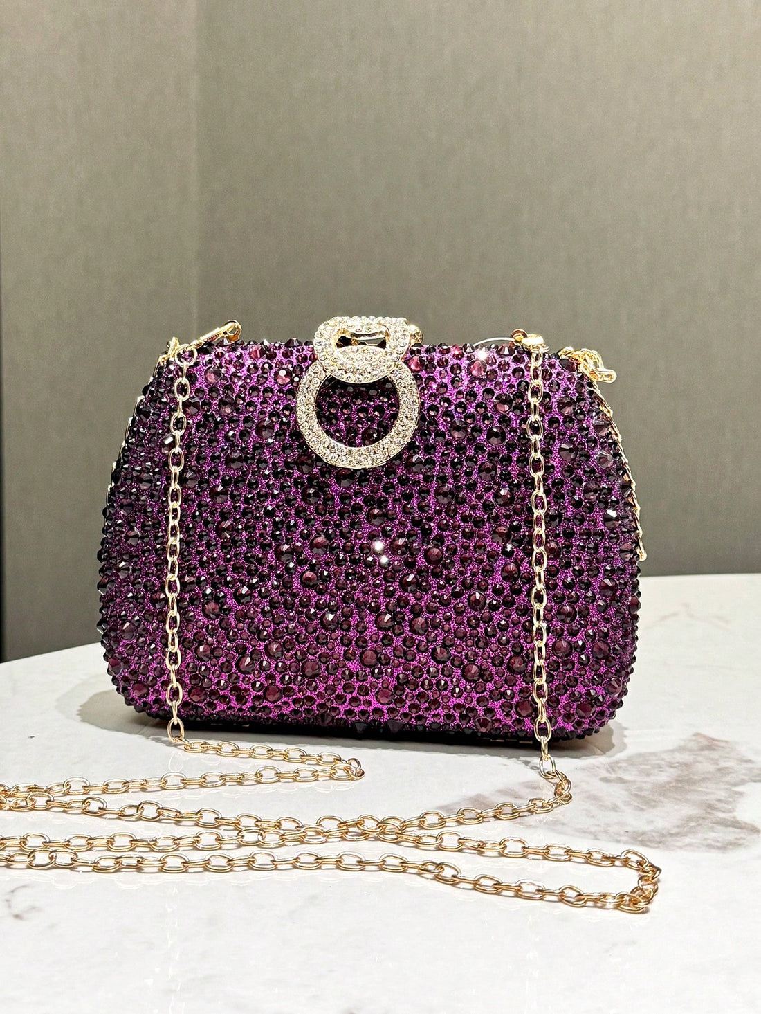 Introducing the Royal Radiance Evening Clutch - a stunning purple rhinestone clutch that adds a touch of elegance to any event. Crafted with care and precision, this clutch will make you feel like royalty. Perfect for any formal occasion, let the sparkling rhinestones add a touch of glamour to your look.