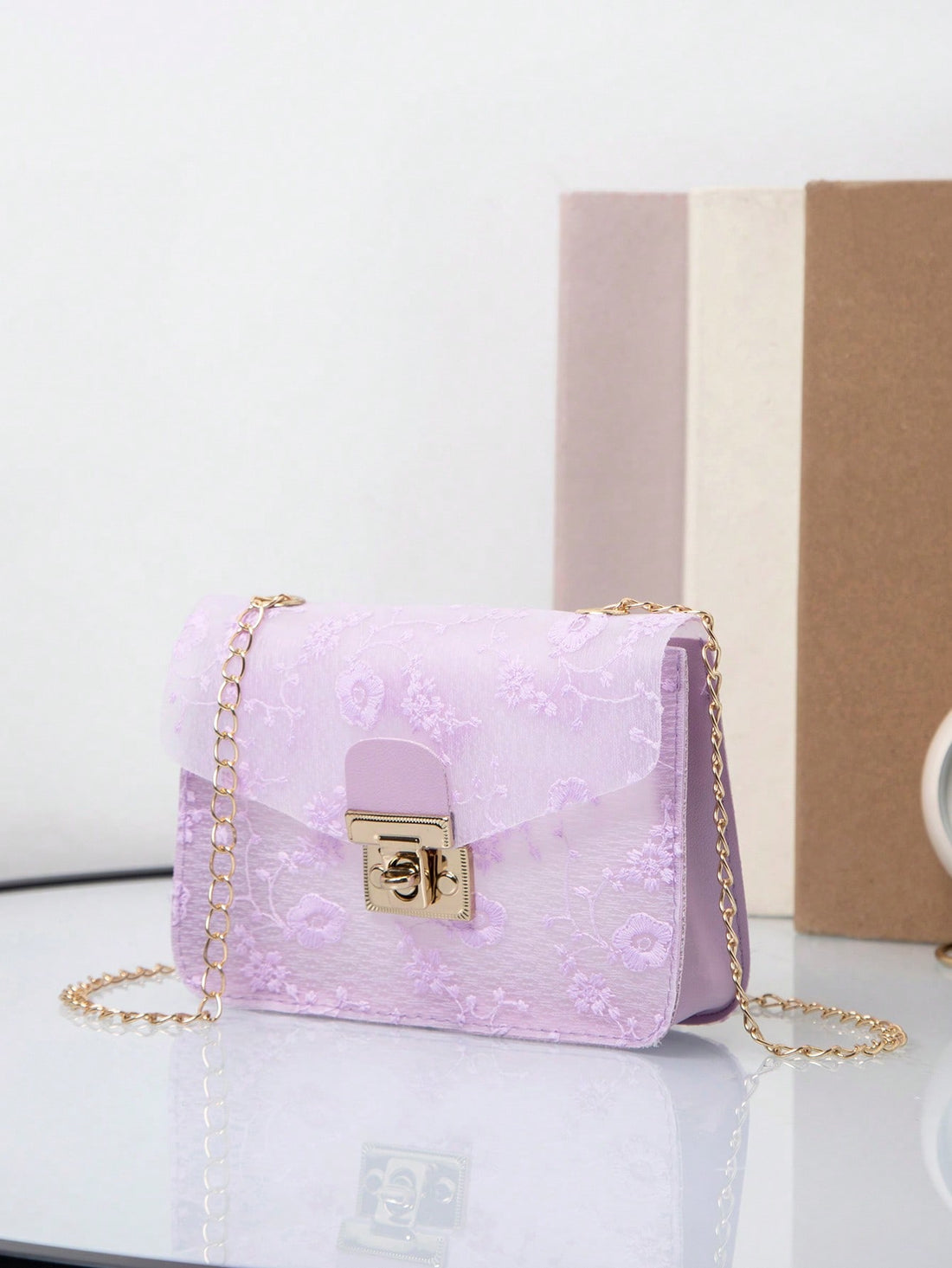 This Elegant Floral Chain Bag boasts a stylish lock buckle design, perfect for versatile wear. Inspired by European fashion, this crossbody bag is a must-have for spring and summer. Elevate any outfit with its chic and elegant floral print.