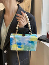 This Blue Sky and Ocean Oil Painting Handbag is perfect for everyday use and travel. Featuring a beautiful, colorful oil painting of the sky and ocean, this handbag has a metal chain shoulder strap for convenience and style. Elevate any outfit with this unique and functional accessory.