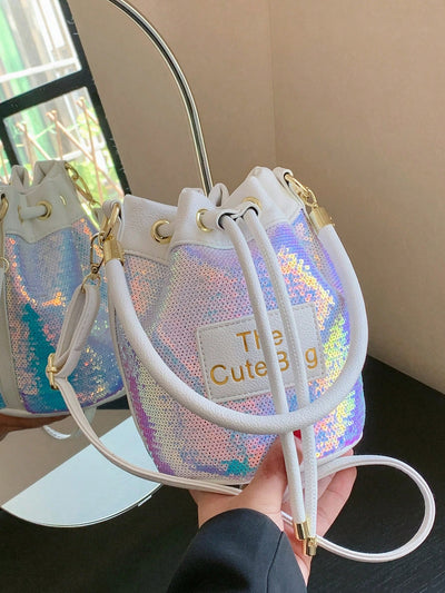 Experience a dazzling combination of style and utility with our new Sequined Bucket Bag from Shimmer and Shine. Perfect for Spring/Summer, this must-have crossbody handbag adds a touch of glamour to any outfit. With its shimmering sequins and spacious design, stay organized and on-trend wherever you go.