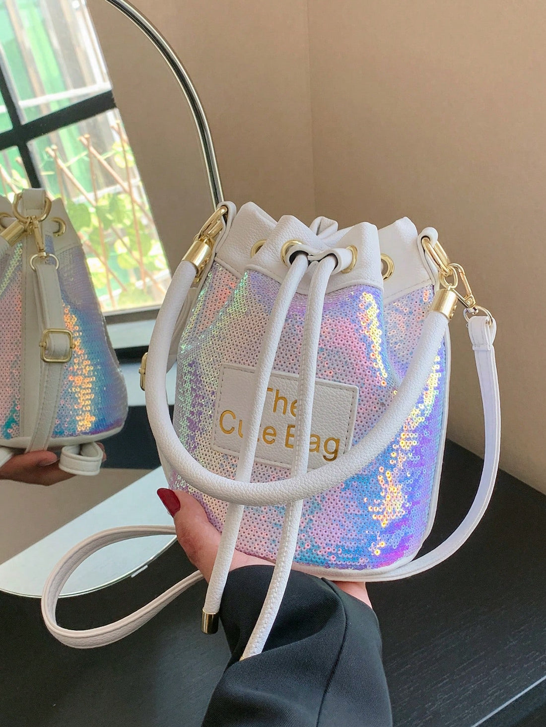 Experience a dazzling combination of style and utility with our new Sequined Bucket Bag from Shimmer and Shine. Perfect for Spring/Summer, this must-have crossbody handbag adds a touch of glamour to any outfit. With its shimmering sequins and spacious design, stay organized and on-trend wherever you go.