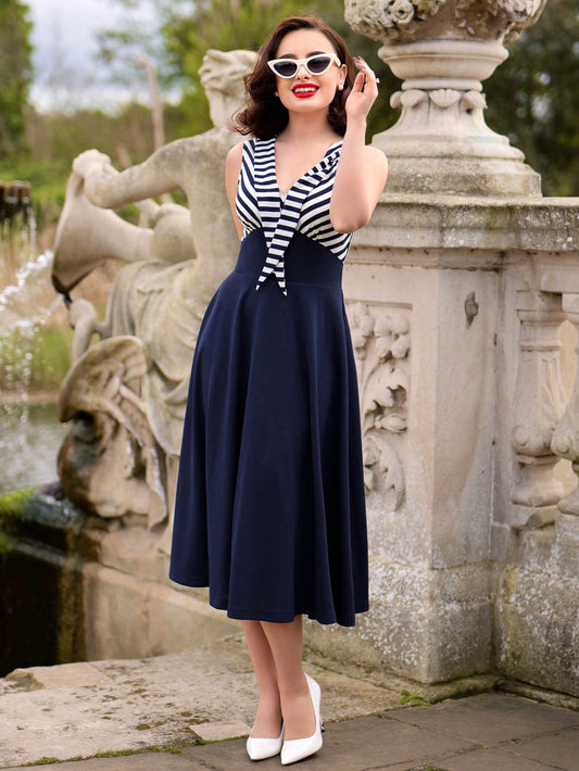 Make a statement this summer with our Vintage Striped Colorblock V-Neck Umbrella Dress. Featuring a classic navy design, this dress is perfect for any occasion. The unique colorblock design adds a touch of retro charm, while the v-neckline adds a modern twist. Stay stylish and comfortable all summer long with this must-have dress.