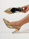 Gold metallic pointed toe slingback pump worn with ruched knot vamp