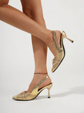 Close-up of gold pointed toe heel showing pleated twist upper