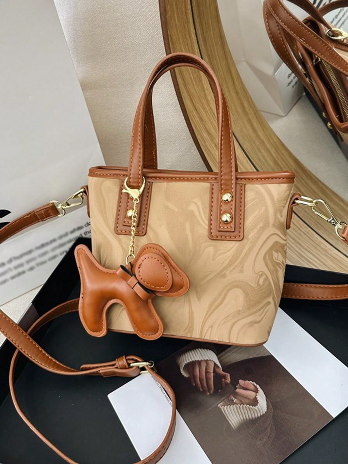 Experience elegance and versatility with our latest handbag. Designed with a fashionable adjustable shoulder strap, this handbag is perfect for any occasion. The perfect blend of style and functionality, this handbag is a must-have for any fashion-forward individual.