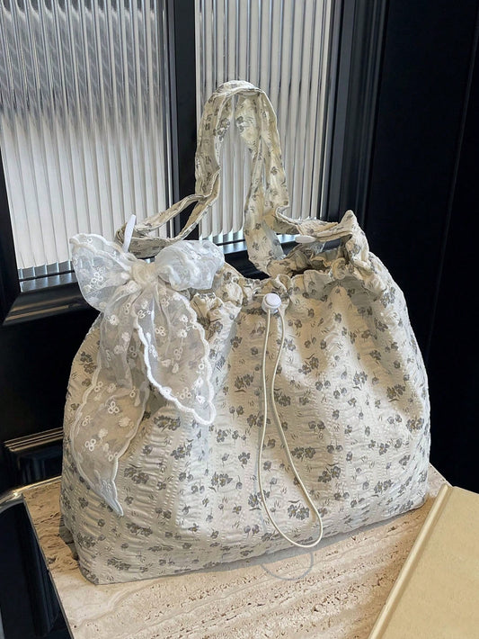 This White Floral Bucket Bag Tote is perfect for students and trendsetters alike. Its spacious design allows for all your essentials while the stylish floral pattern adds a touch of elegance. Crafted with durable materials, this bag is built to last. Stay organized and on-trend with this must-have tote.