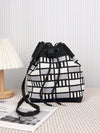 This stylish and lightweight crossbody bucket bag is a must-have for every mom's outdoor adventures. With its sleek black and white design, it offers the perfect combination of fashion and function. Keep all your essentials organized and easily accessible while enjoying hands-free convenience.