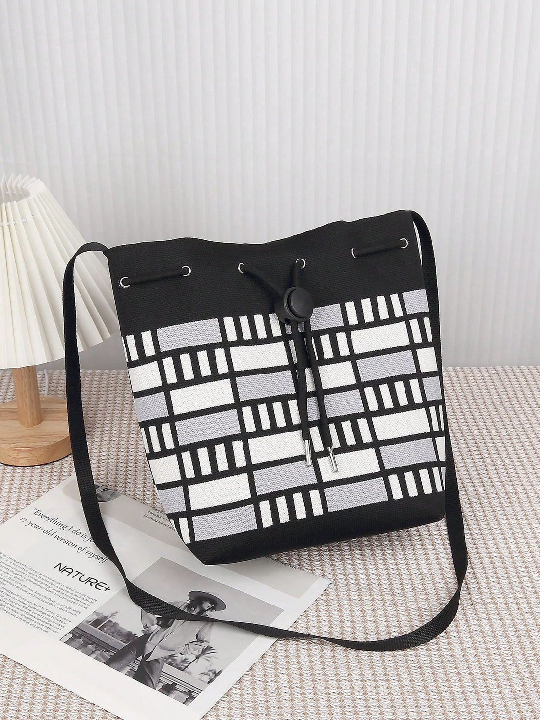 This stylish and lightweight crossbody bucket bag is a must-have for every mom's outdoor adventures. With its sleek black and white design, it offers the perfect combination of fashion and function. Keep all your essentials organized and easily accessible while enjoying hands-free convenience.