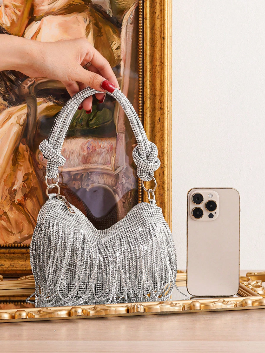 Elevate your evening look with our Sparkling Elegance: Fringed Clutch Bag. The shimmering design and fringed details exude glamour, making you stand out in any occasion. Perfect for storing your essentials, this bag adds a touch of elegance to your outfit. Make a statement with this must-have accessory!