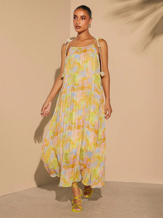 Effortlessly elevate your summer style with our stylish pleated print tie-strap dress. The lightweight, breathable fabric ensures comfort in warm weather, while the playful tie-straps add a touch of flair. Perfect for any occasion, this dress is a must-have addition to your summer wardrobe.