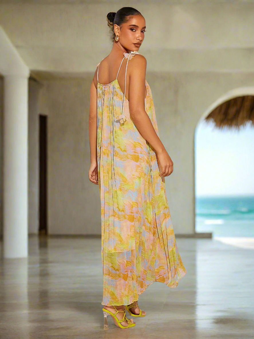Introducing the ultimate summer must-have: the Radiant Pleated Print Tie-Strap Dress. With its vibrant print and elegant tie-straps, this dress will make you stand out at any occasion. Made with high-quality materials, it's both stylish and comfortable. Don't miss out on adding this statement piece to your summer wardrobe.
