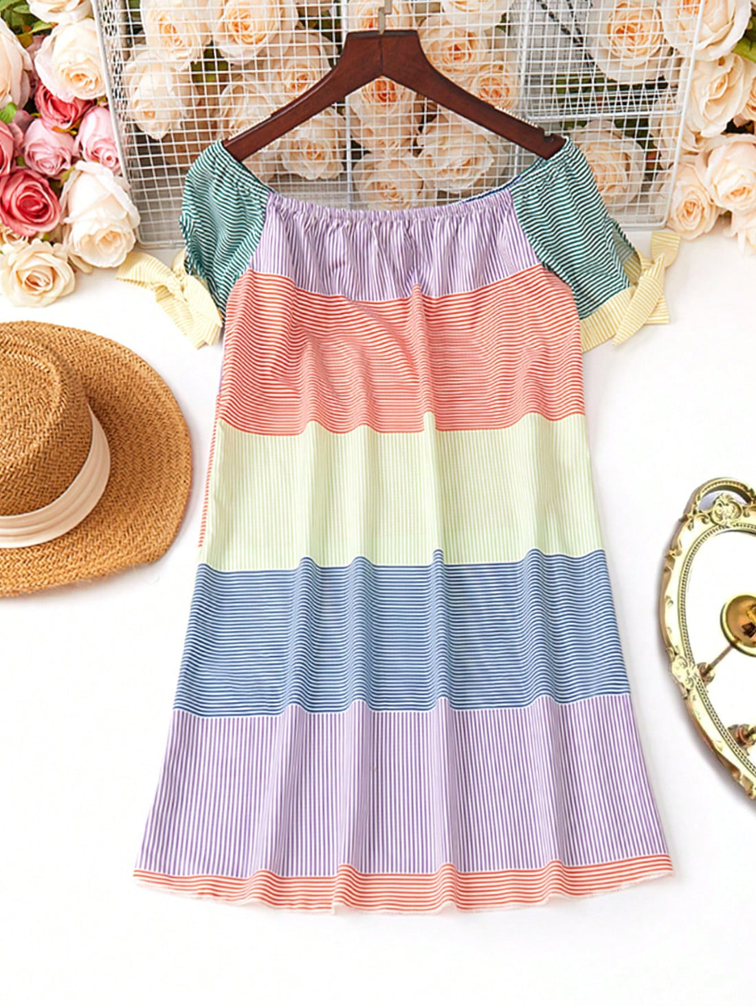 Get ready to rock your summer look with our Chic Summer Vibes midi dress! Featuring a trendy off-shoulder design and a playful tie hem, this dress is perfect for any occasion. The striped color block adds a touch of whimsy. Stay chic and stylish all summer long!