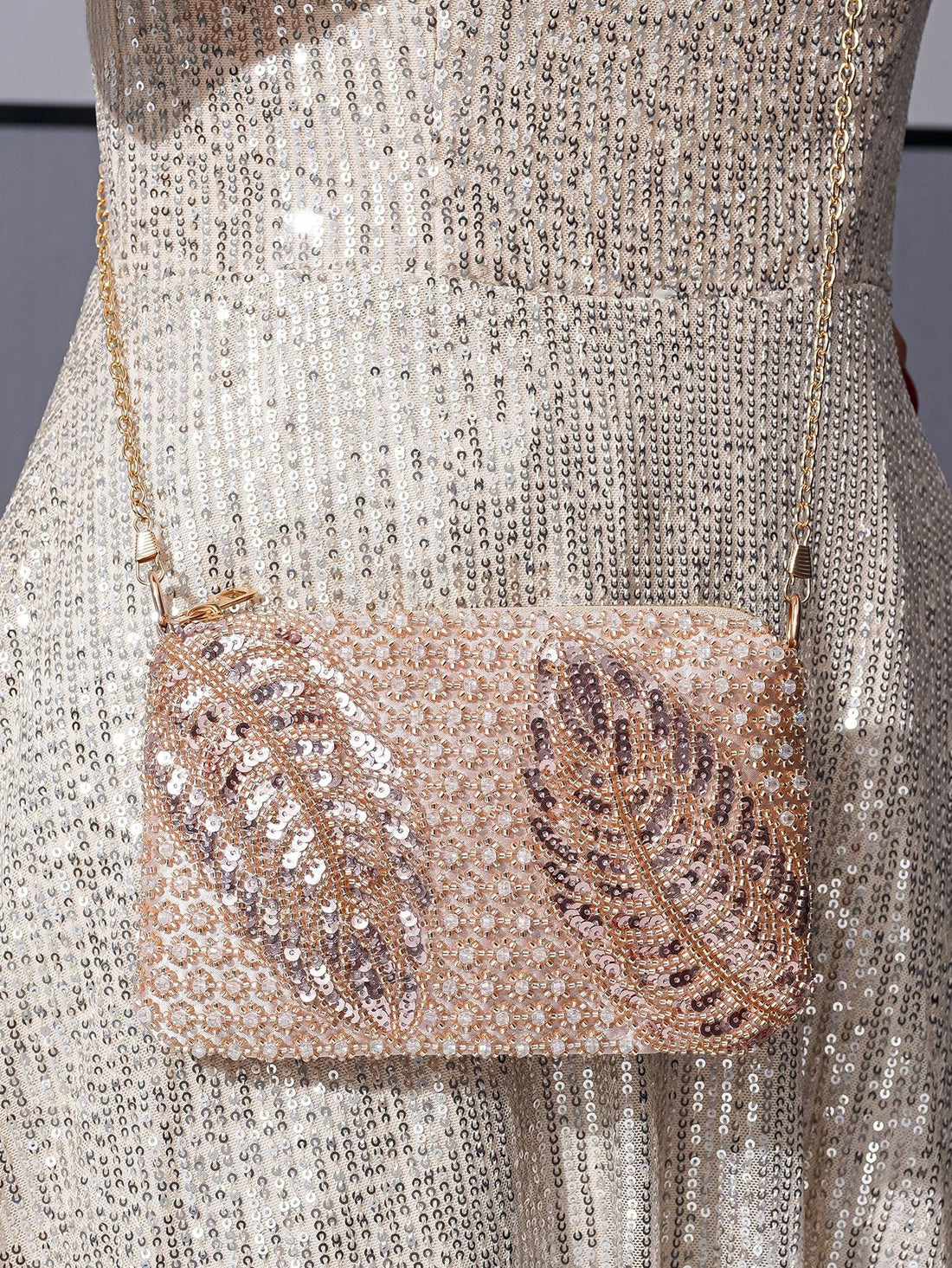 Elevate your party outfit with the Sparkle and Shine clutch bag. The glitter leaf shape adds a touch of glamour to any formal occasion. With a spacious interior, it can hold all your essentials while the sturdy clasp keeps them secure. Perfect for adding a hint of sparkle to your look.