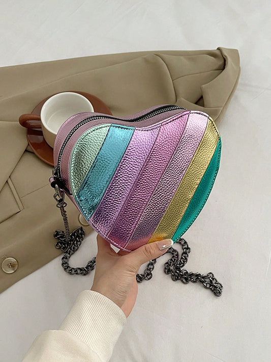 This rainbow striped heart crossbody bag is a perfect mini must-have for kids! With its eye-catching design and convenient crossbody strap, it's both stylish and practical. Made with durable materials, it's ideal for carrying their essentials while on the go. Get your child one today and watch their excitement grow!