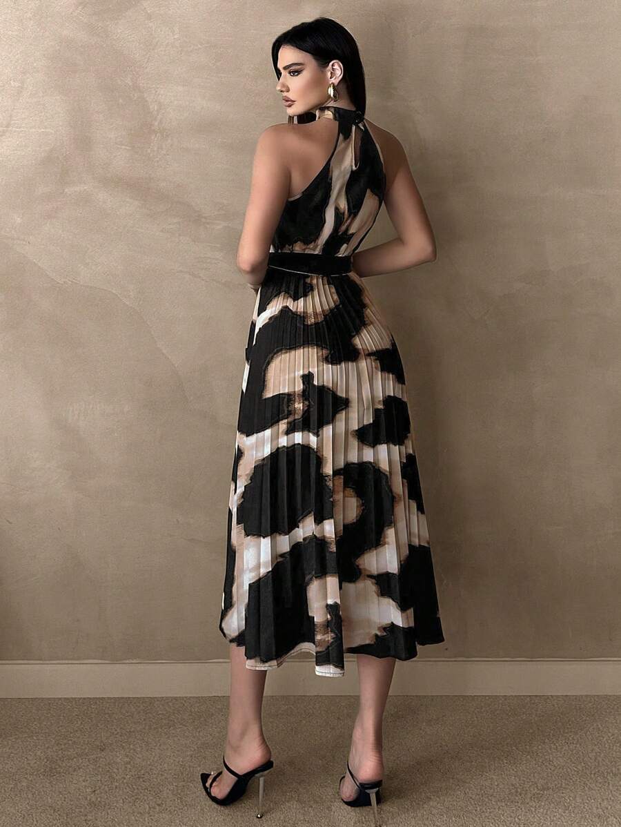 Front view of abstract print pleated halter midi dress with tie belt