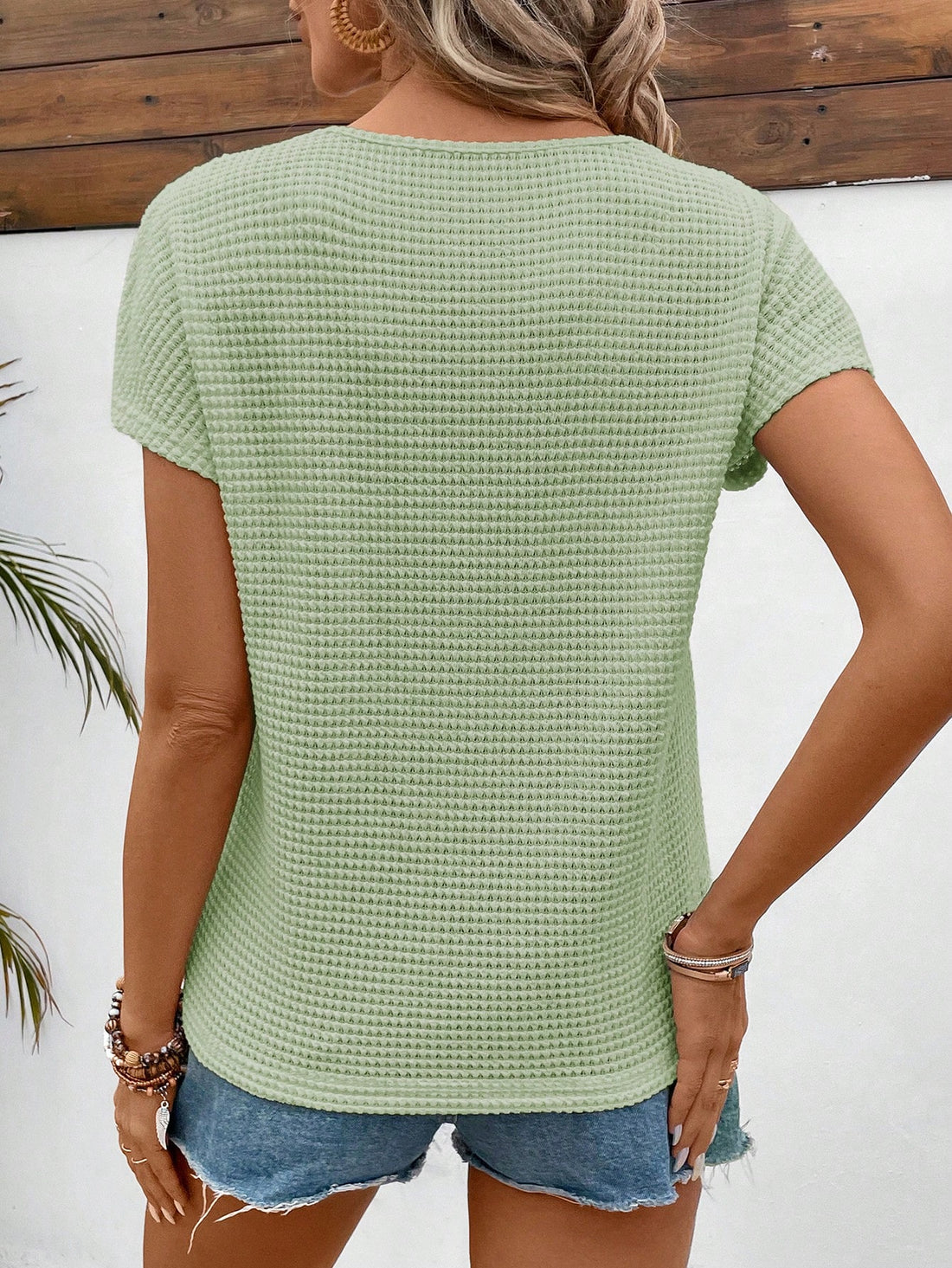 This short sleeve t-shirt features a delicate patchwork of mint green lace and a comfortable batwing style, made with waffle fabric for a soft touch. Enjoy both style and comfort with this unique piece.