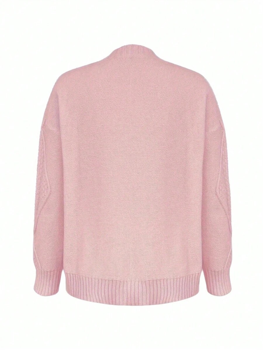 Front view of pastel pink cable-knit cardigan with drop shoulders and buttons for casual styling