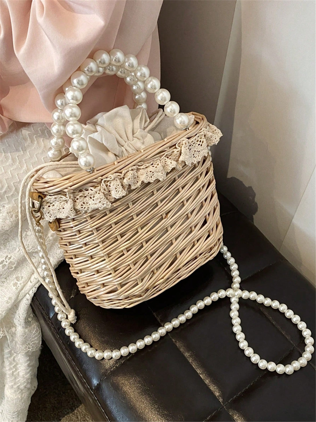 This handmade wicker bag is adorned with delicate pearls, making it the perfect crossbody souvenir. Its intricate design and sturdy construction make it a stylish and practical choice. With its unique combination of beauty and functionality, it's an ideal accessory for any occasion.