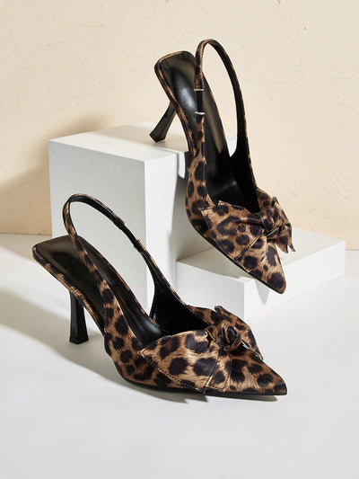 Elevate your style with Wild Nights: Leopard Print Pointed Toe Heels. Featuring a bold leopard print, pointed toe, and playful bowknot and ankle straps, these heels are perfect for making a fierce fashion statement. With a professional tone, these heels are a must-have for any wardrobe.
