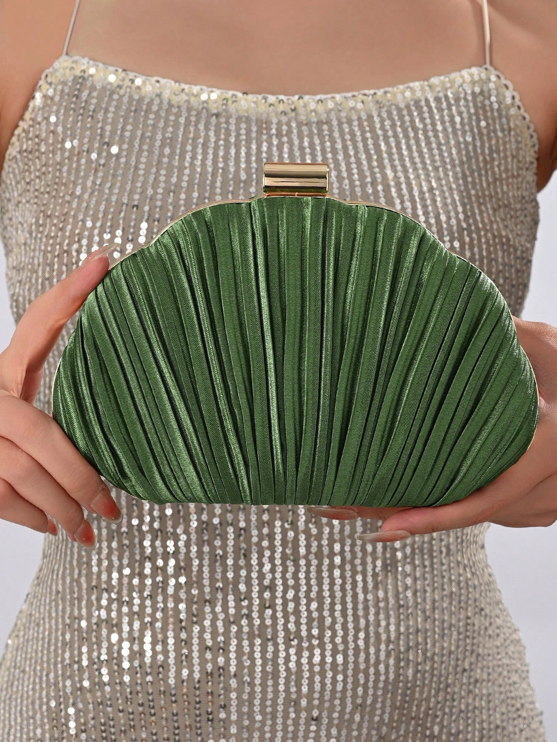 Our Elegant Pleated Satin Evening Clutch is the perfect accessory for prom and formal events. Made with high-quality satin and featuring a chic pleated design, this clutch exudes elegance and sophistication. The included chain strap allows for easy hands-free carrying, making it both stylish and functional. Enhance your outfit with this must-have accessory.