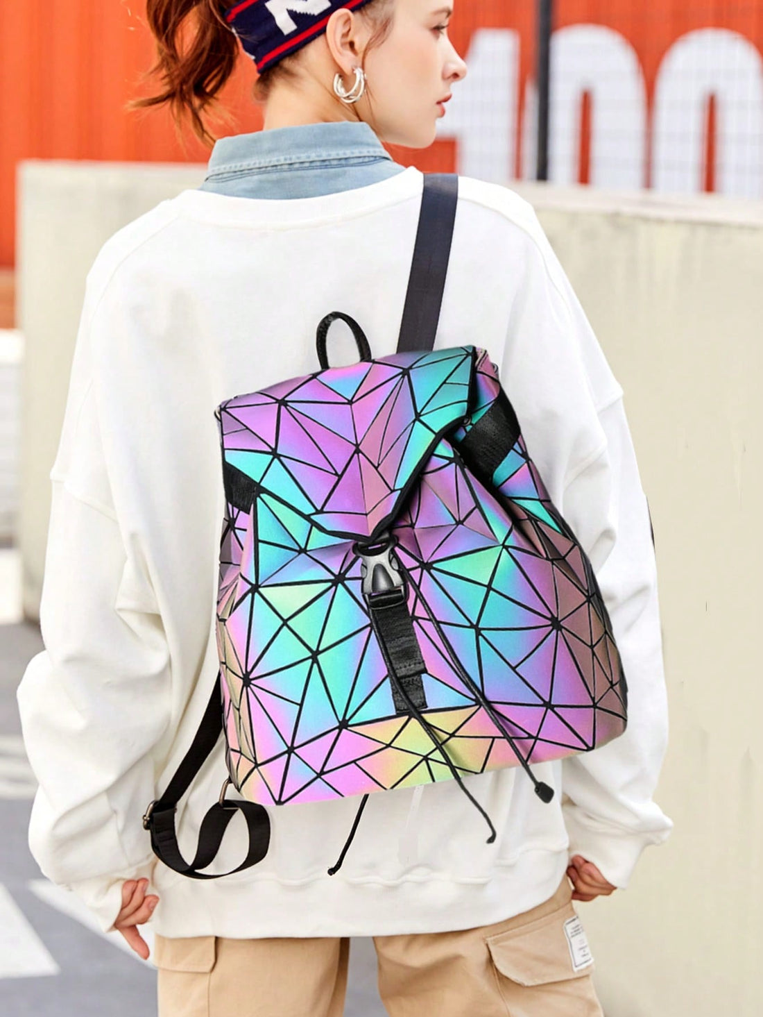 Experience the magic of the Luminous Aura backpack. Its geometric holographic design will turn heads and make you stand out in a crowd. With its shoulder strap, this bag is perfect for any on-the-go adventure. Stay organized with its spacious interior and multiple pockets. 