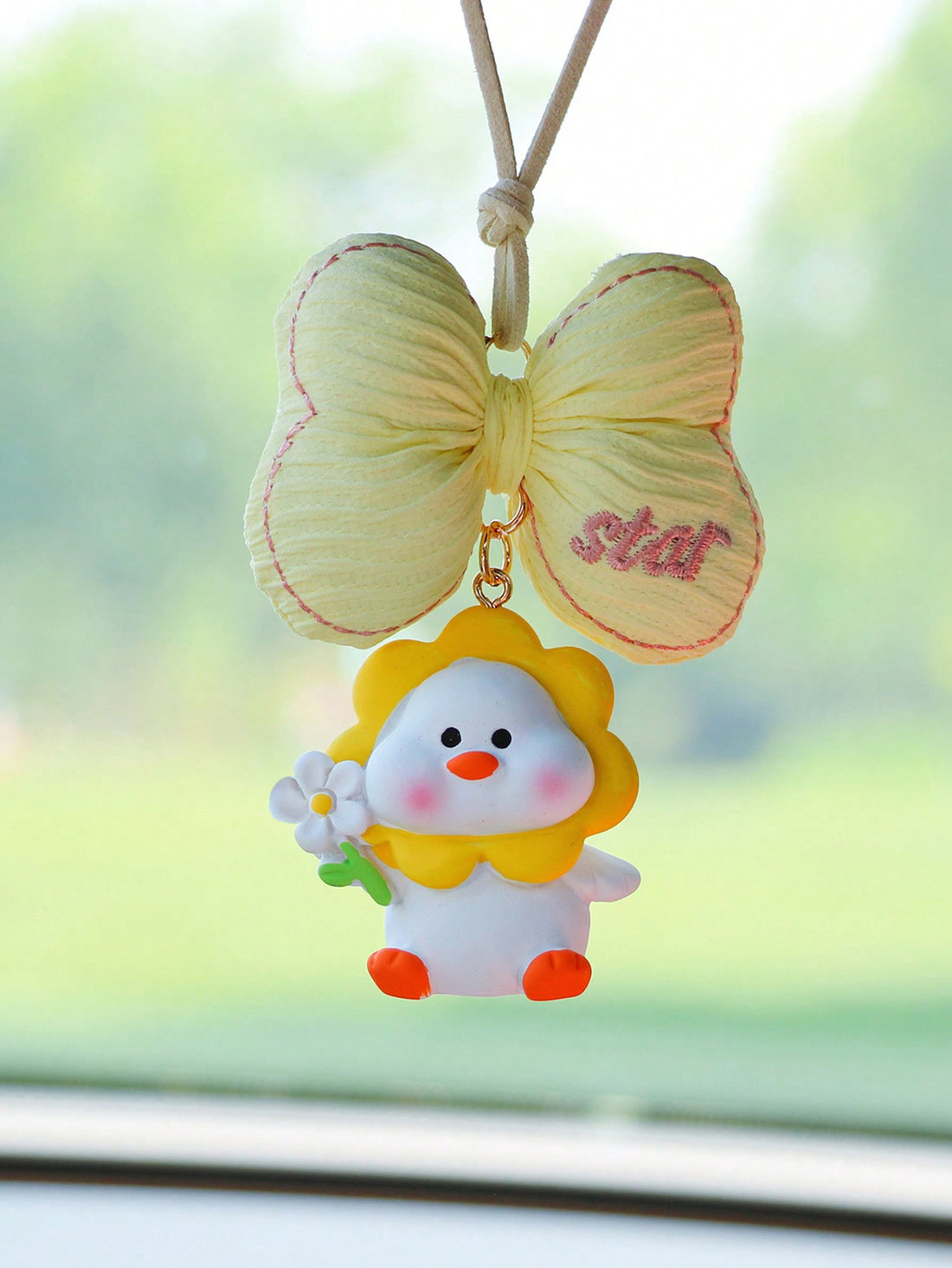 Add a touch of whimsy to your car with this playful yellow bowknot flower and duck interior ornament. Made to bring a cheerful and charming vibe to your vehicle, this unique accessory is perfect for those looking to add a dash of personality to their daily commute.