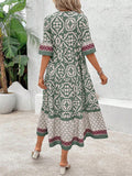 Back view of green boho printed dress with loose fit and ruffle hem