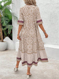 Back view of beige boho dress with short sleeves and tiered skirt