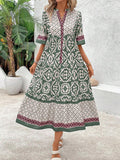 Green retro graphic dress front view with gathered waist and flared skirt