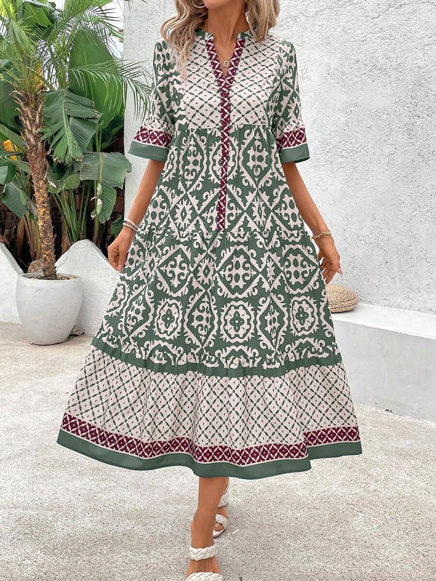 Green retro graphic dress front view with gathered waist and flared skirt